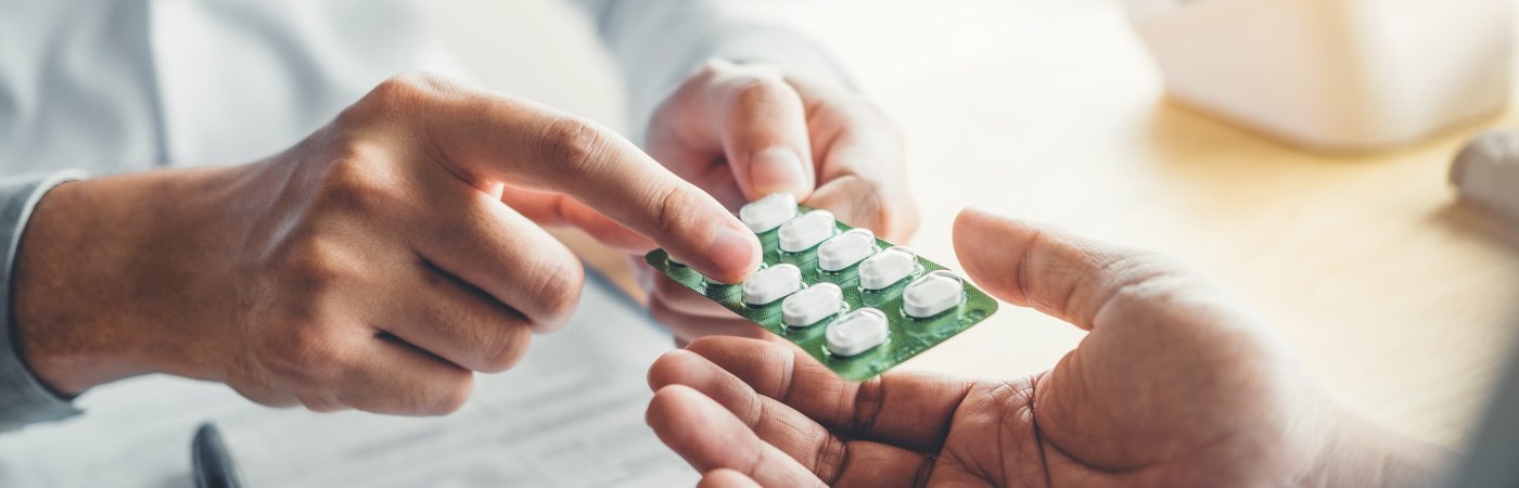 Doctor explains prescription pills to a patient