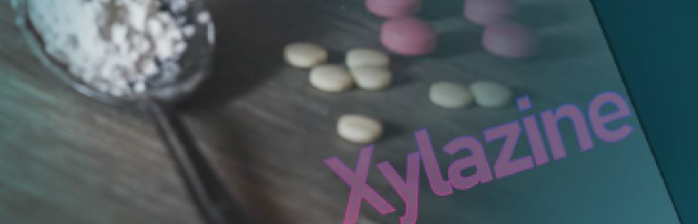 Xylazine: A Drug That Naloxone Can't Combat. Get Smart About Drugs. Image of pink and white pills on a table top with a spoonful of white powdery substance