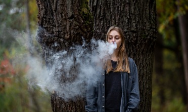 Teenager vapes