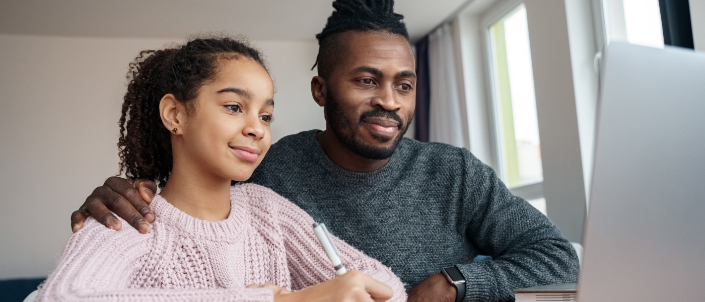 Father and daughter with computer