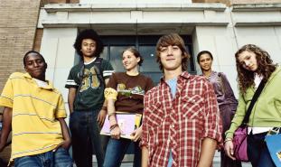 teens standing in front of school