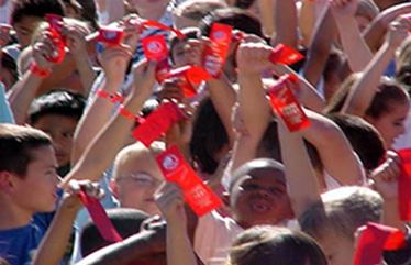 kids waving red ribbons