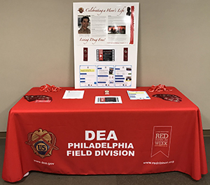 Red Ribbon Table Outside DEA Office