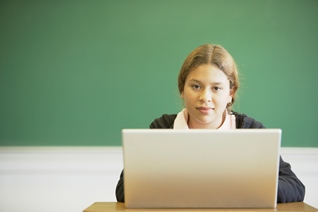 girl with laptop in classroom