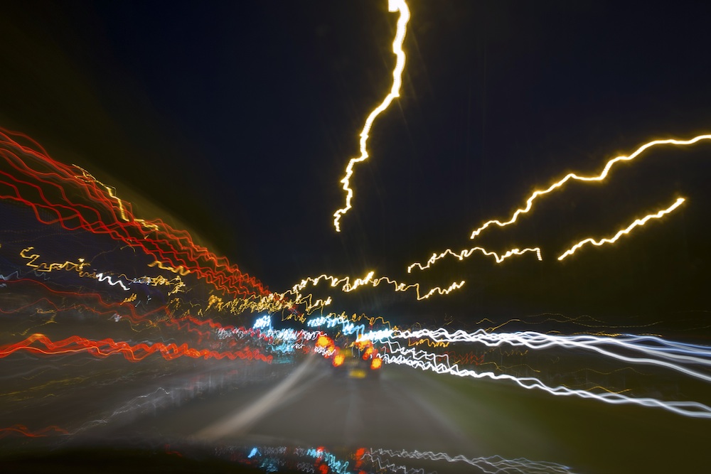 Blurred nighttime road from perspective of a drugged driver