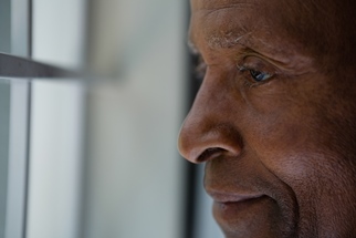 older man looking out of window
